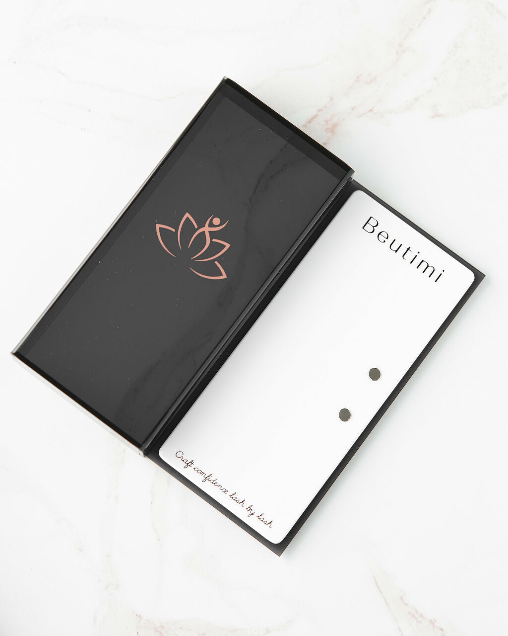 Beutimi Lash Visionary Tile displayed open in black packaging with rose gold lotus logo and white interior palette with magnetic tool holders