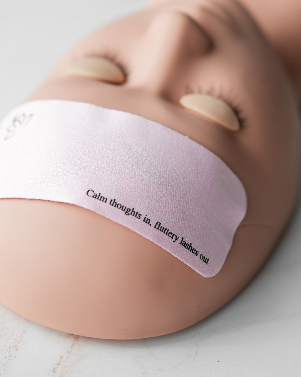 Beutimi Forehead Cover in pink displayed on a person's forehead with motivational text and closed eyes visible above