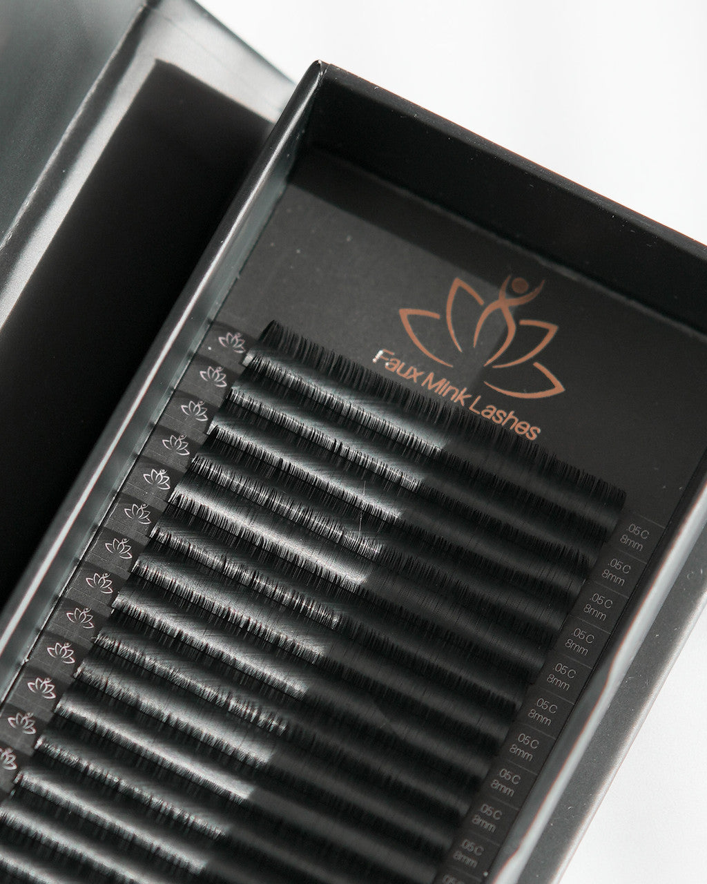 Beutimi FauxMink Lashes 0.05MM arranged in rows inside black packaging tray with copper branding logo