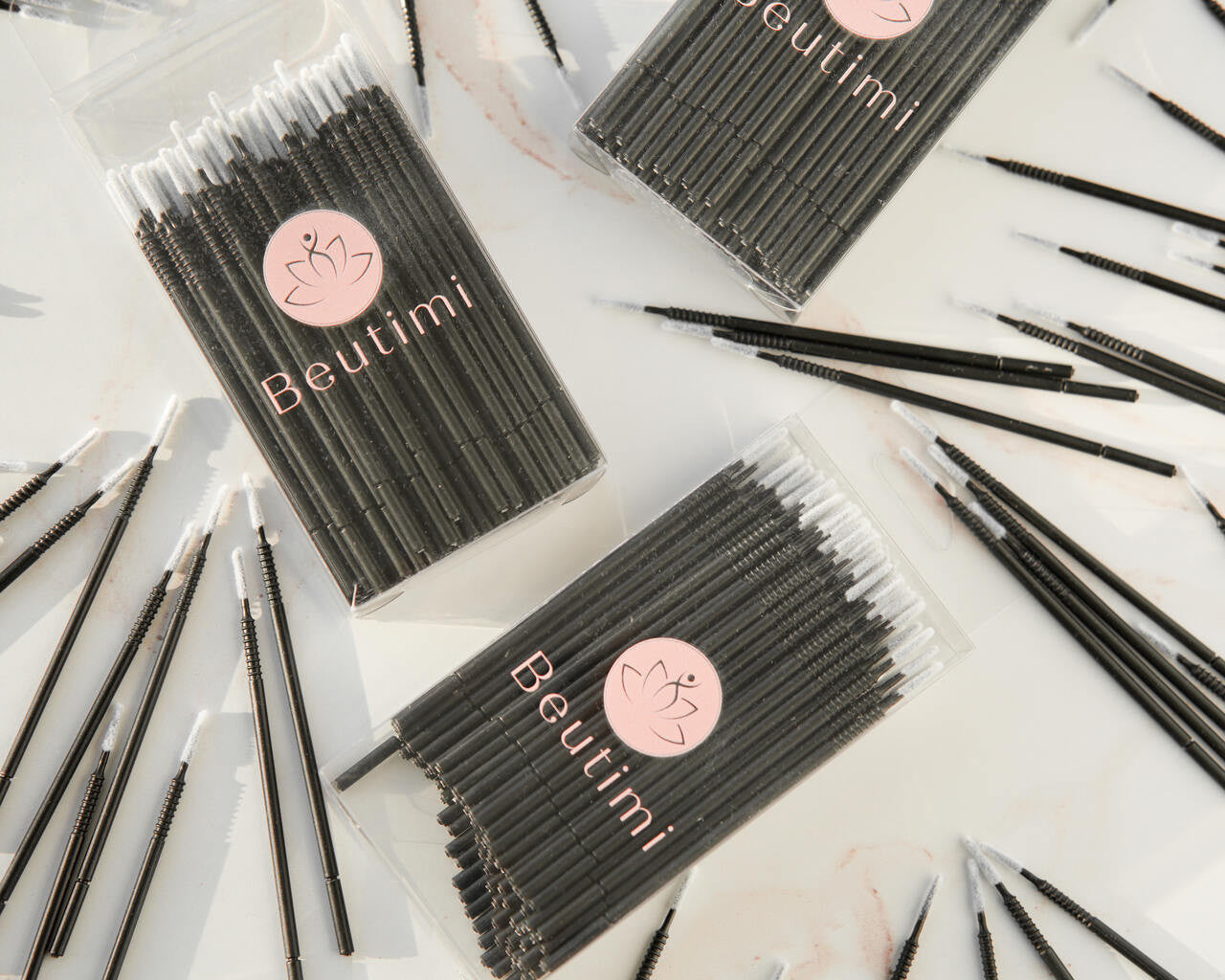 Beutimi Masterpiece Detailers 100-pack micro brush applicators displayed in black packaging with pink logo, surrounded by individual black brushes