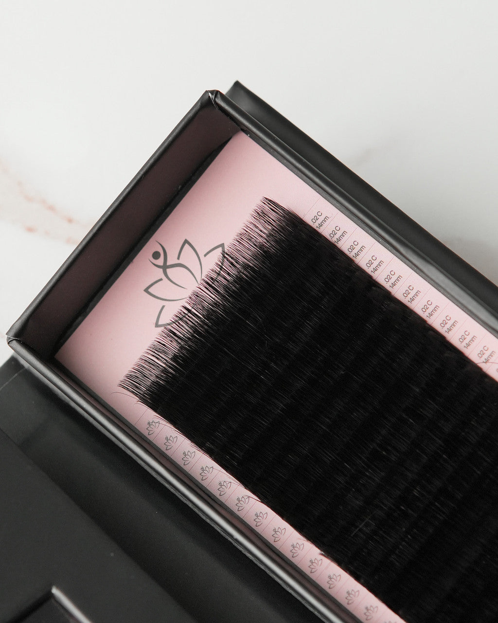 Beutimi FauxMink Lashes 0.02MM displayed in open black case with pink interior showing black lash strips on labeled bands