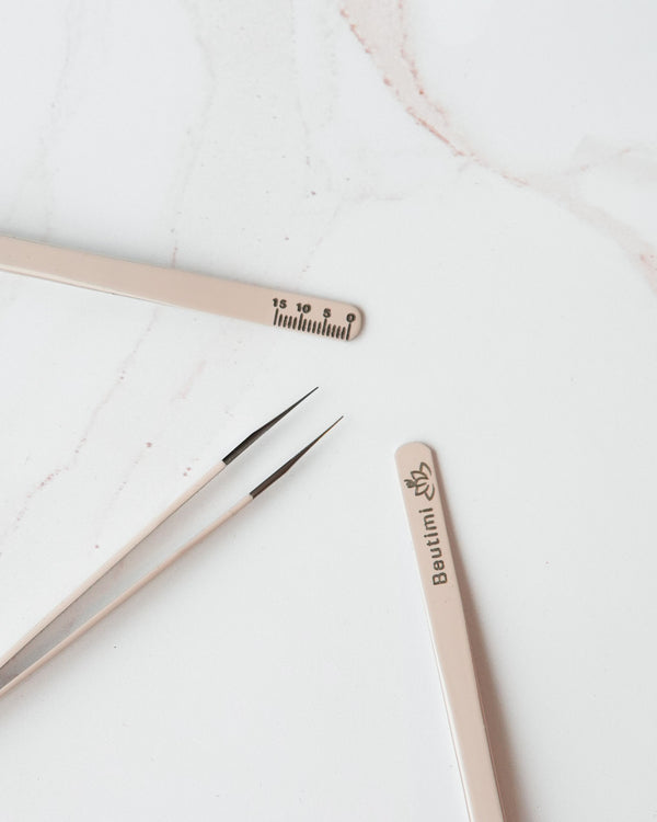 Beutimi On Point Tweezer displayed with fine-tip tweezers and ruler on marble surface showing product details