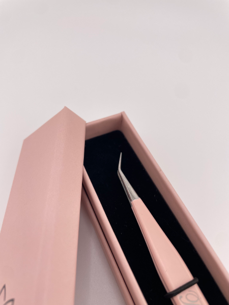 Beutimi Be Bold Tweezer displayed in pink packaging with black interior lining, shown at an upward angle