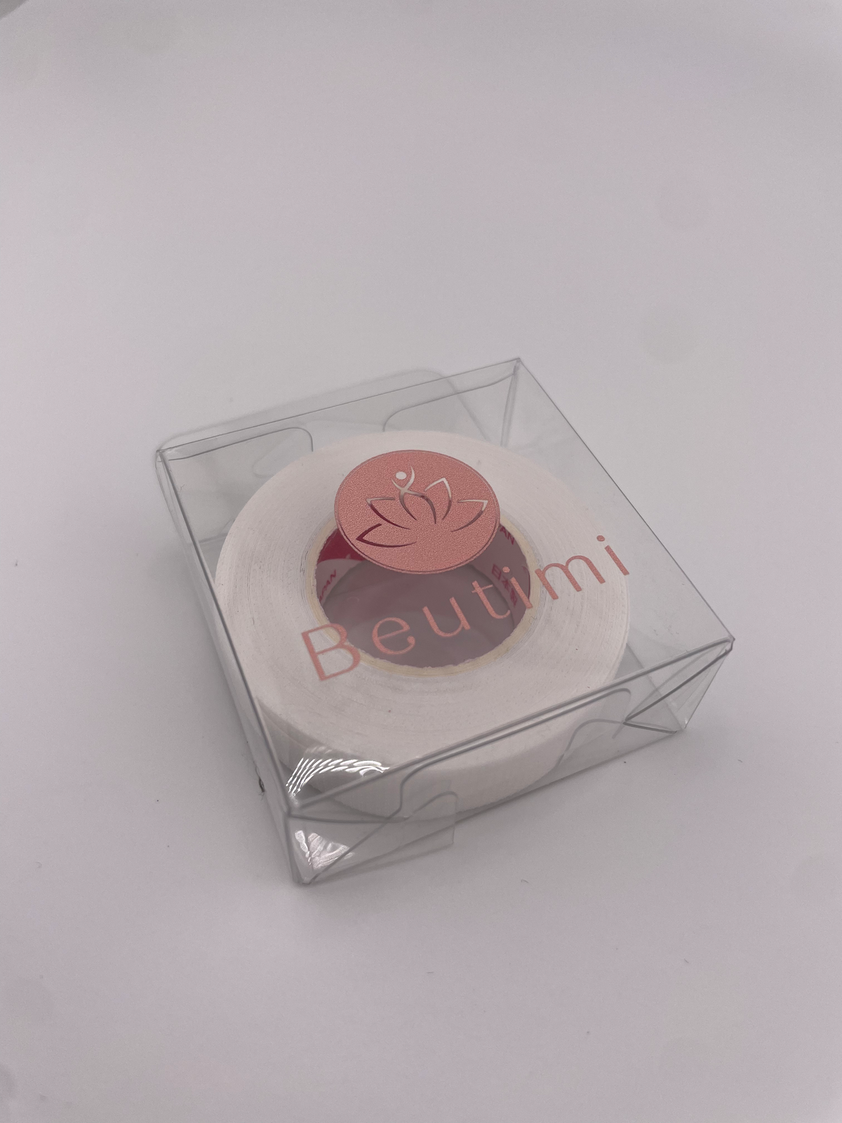 Round beauty product with 'Beutimi' branding in a clear box on a light gray background