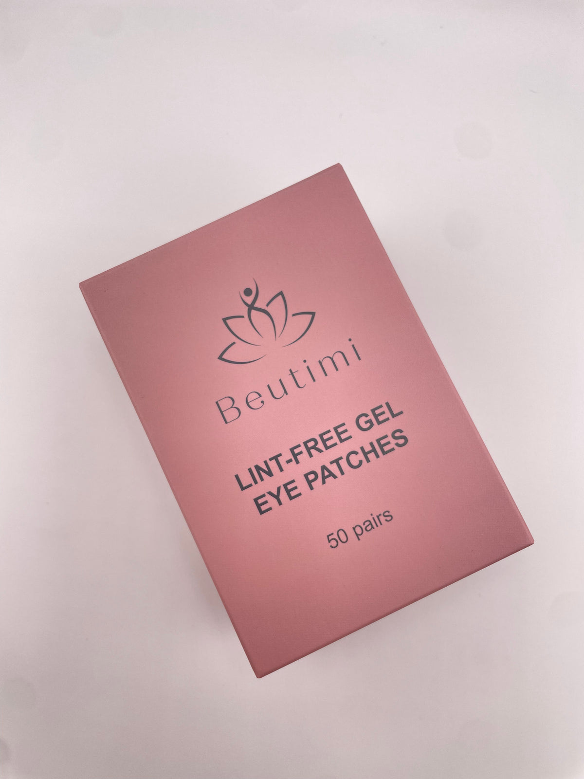 Beutimi Lint Free Gel Eye Patches in pink packaging displayed at an angle on a white background