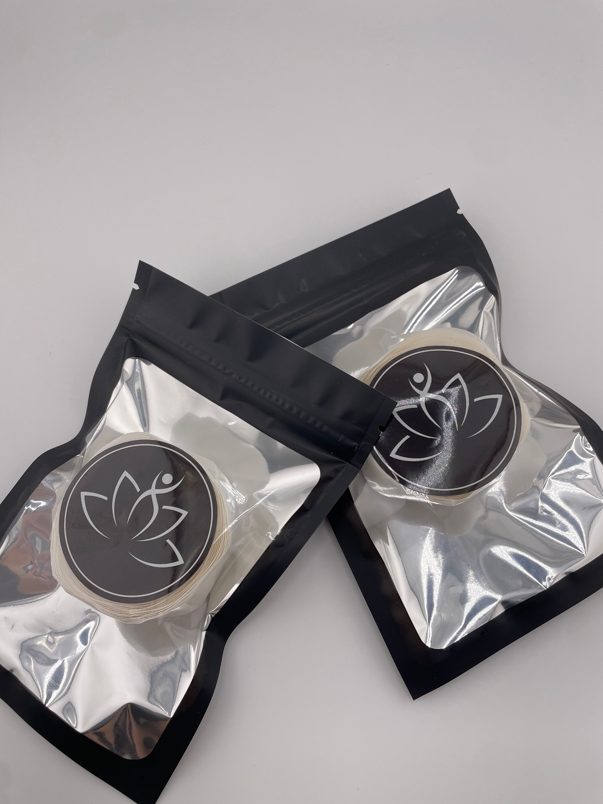 Beutimi Sticky Dots For Lotus Bouquet Flower Cup displayed in two clear pouches with black labels featuring lotus logo designs