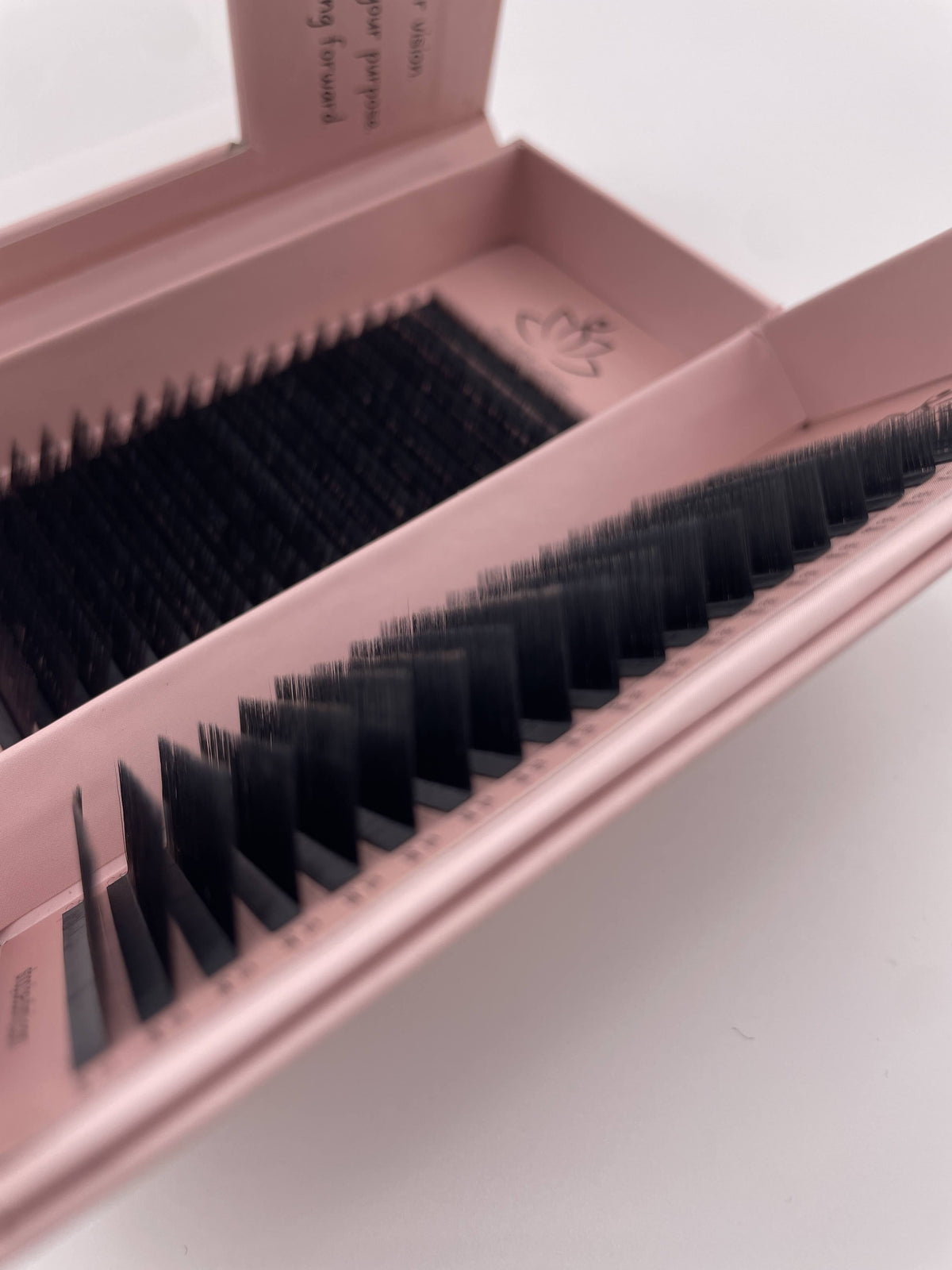 Beutimi FauxMink Lashes 0.03MM displayed in pink packaging showing black segmented lash strips arranged in rows