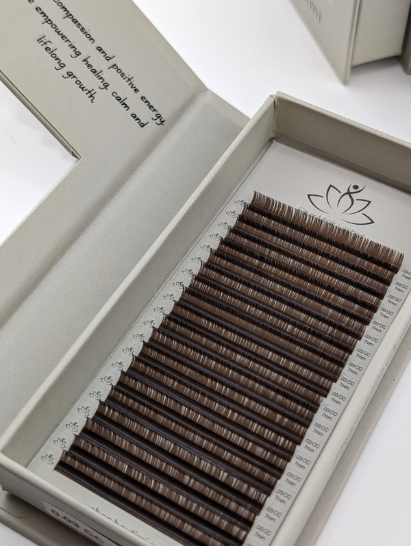 Beutimi Dark Brown FauxMink Lashes 0.05MM arranged in organized rows inside white packaging tray with lotus logo
