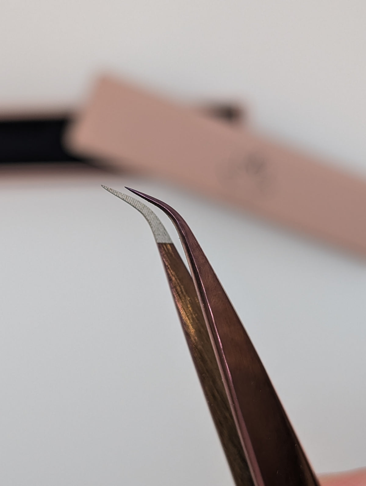 Beutimi Be Bold Tweezer with curved fiber tip and brown handle displayed against white background