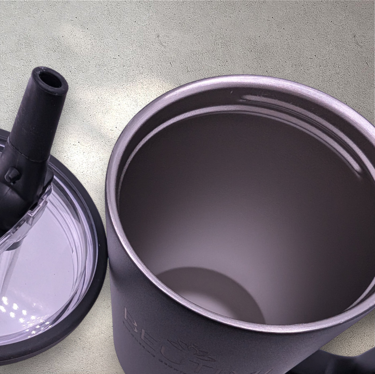 Beutimi Leakproof Hydrojug in black displayed open with flip straw lid on gray surface