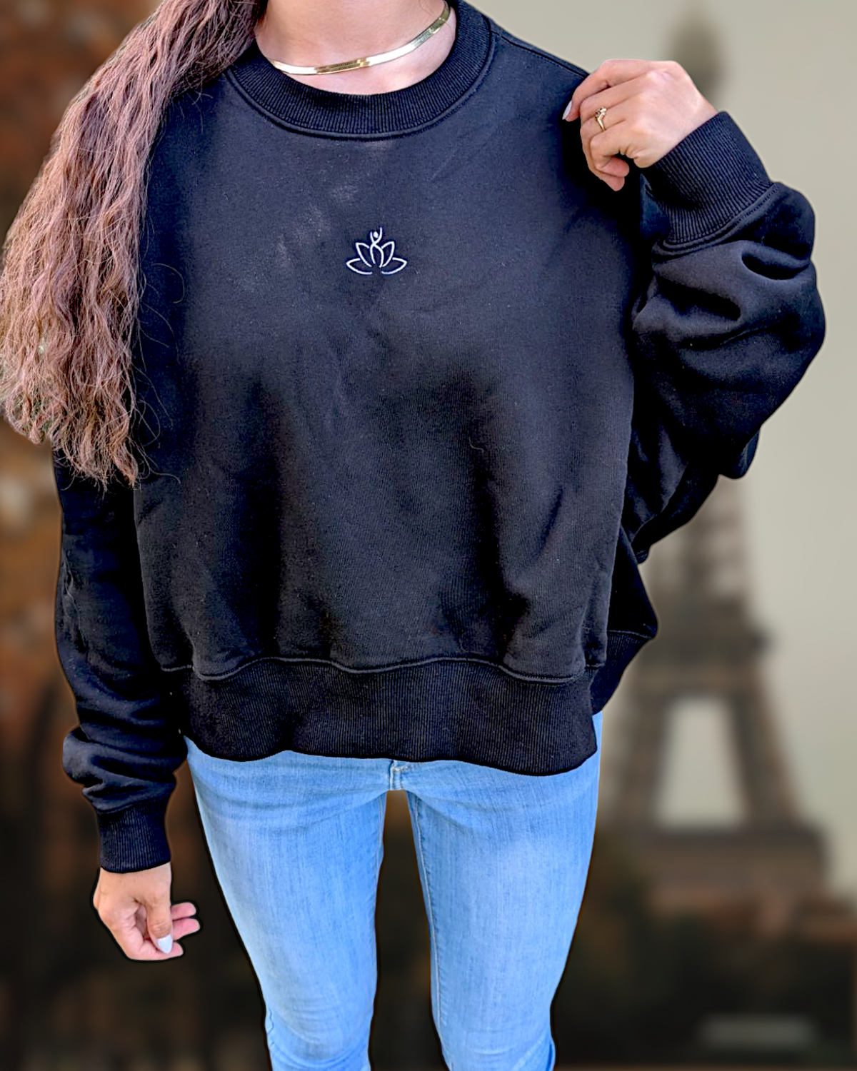 Beutimi Lash Artist Sweater in navy blue with white lotus emblem, worn with light blue jeans and accessories