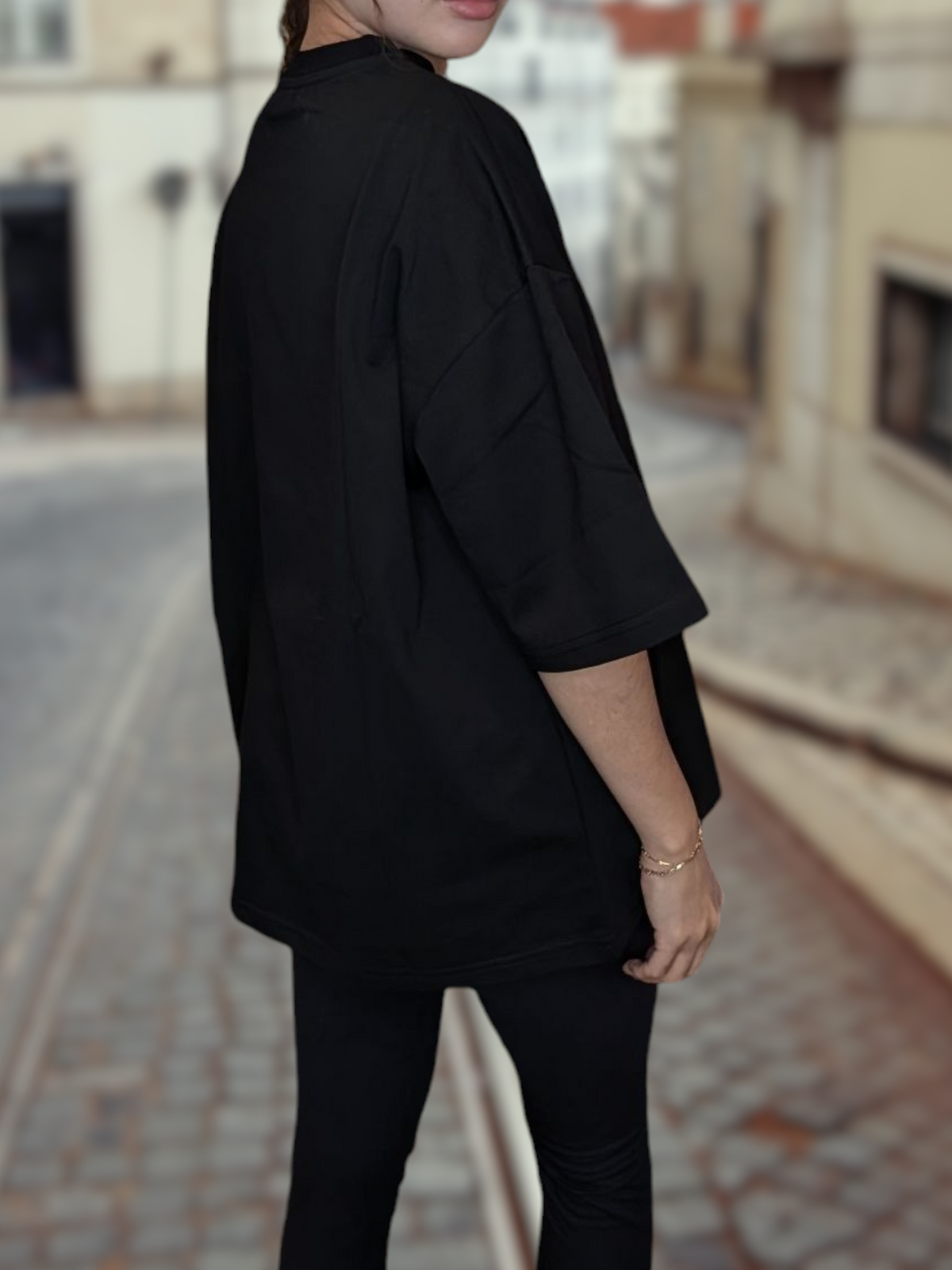 Beutimi Authentic T-Shirt in black, shown from behind on a woman in an outdoor street setting