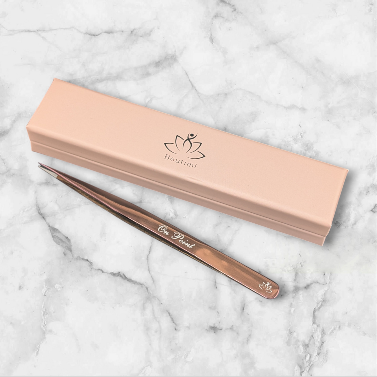 Beutimi On Point Tweezer displayed with its peach packaging and rose gold tool against marble background