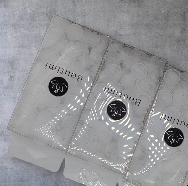 Three clear Beutimi Lotus Bouquet Ring packages with black logos displayed on concrete surface, showing disposable lash extension rings inside