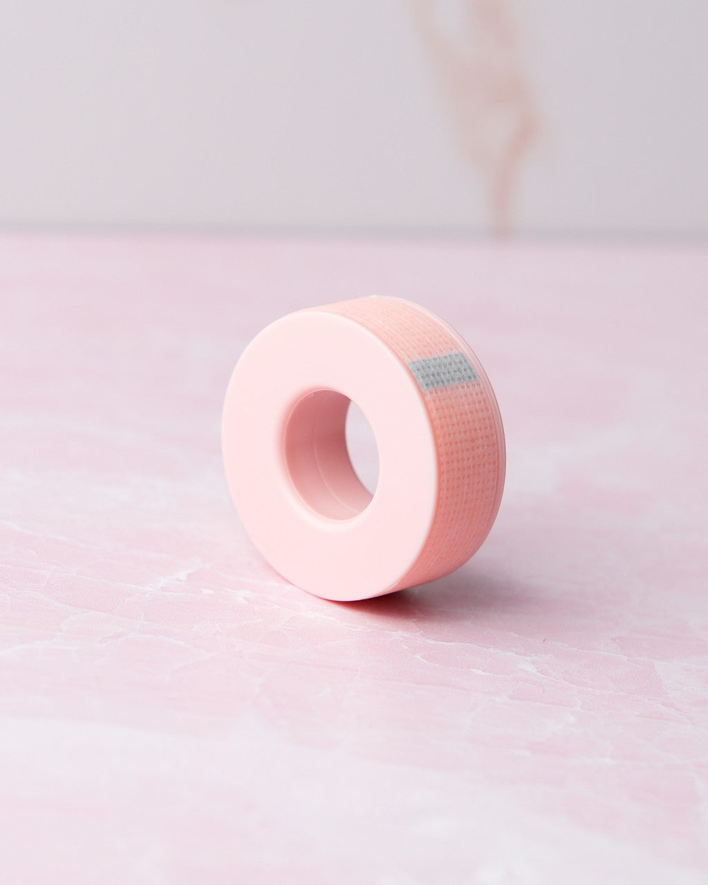 Beutimi Empower Gel Tape roll in pink with gray label strip displayed at angle on light background