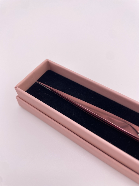 Beutimi On Point Tweezer displayed in rose gold packaging with black velvet interior, angled view showing the precision tool