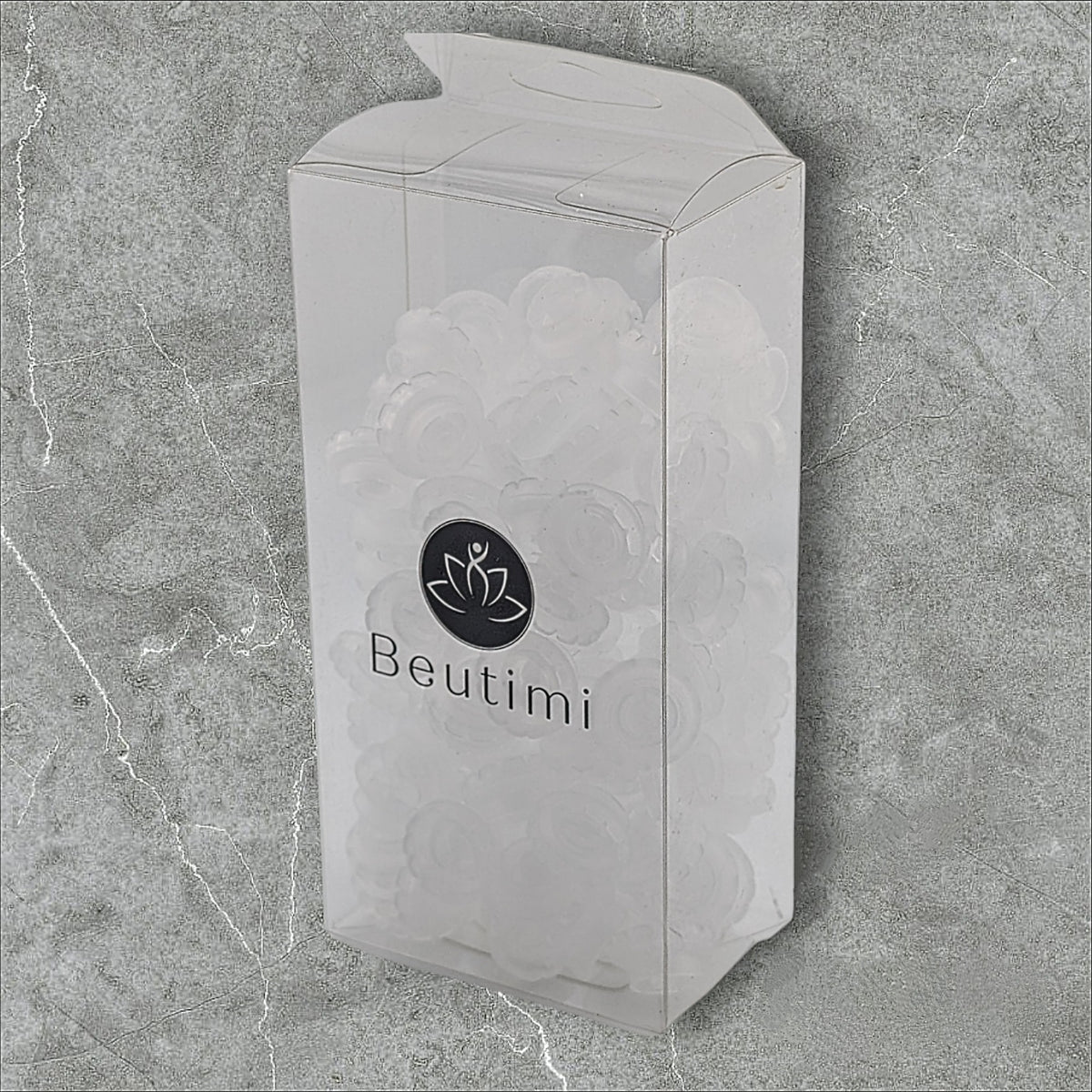Beutimi Lotus Bouquet Ring white packaging with lotus logo displayed against textured gray background